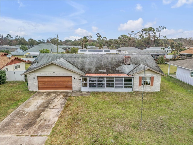 view of front of house with a garage and a front lawn