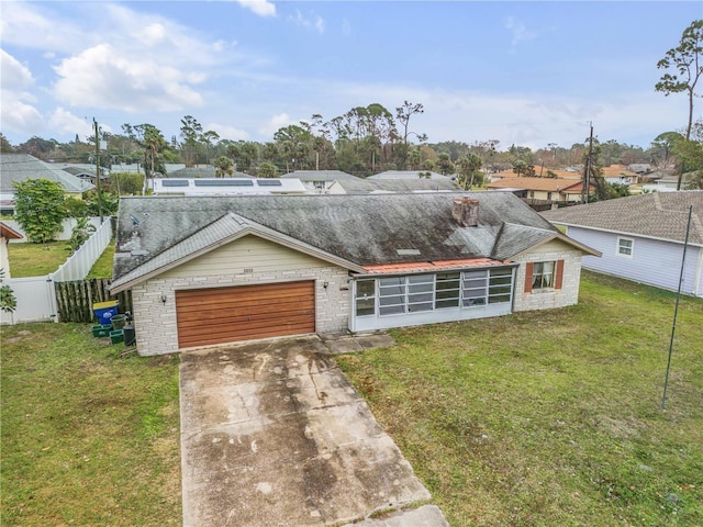 view of front of house with a garage and a front yard