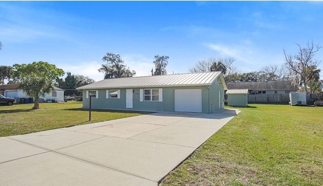 ranch-style house with an outbuilding and a front lawn