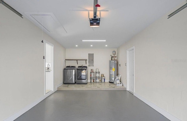 garage featuring a garage door opener, electric panel, electric water heater, and washing machine and clothes dryer