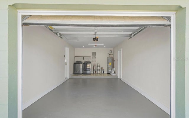 garage with a garage door opener, electric panel, washing machine and dryer, and water heater