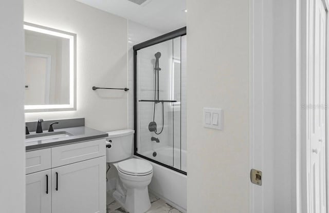 full bathroom with vanity, enclosed tub / shower combo, and toilet