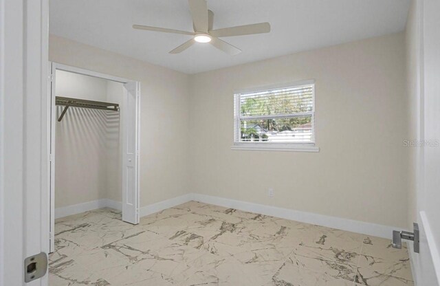 unfurnished bedroom featuring ceiling fan and a closet