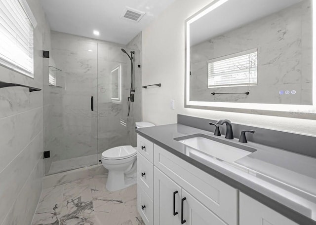 bathroom with vanity, toilet, and walk in shower