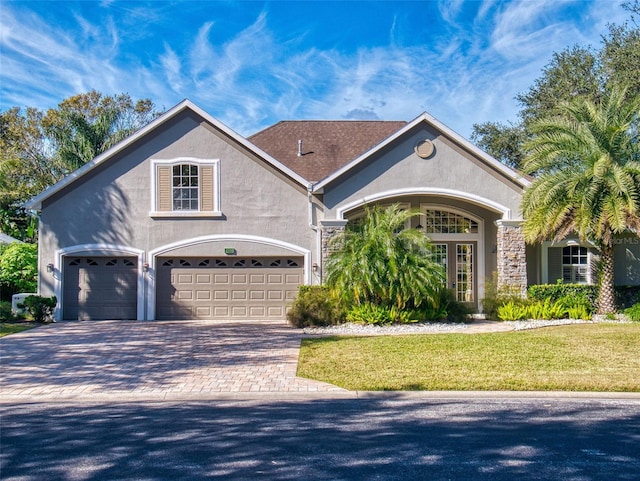 view of front of house featuring a garage and a front yard