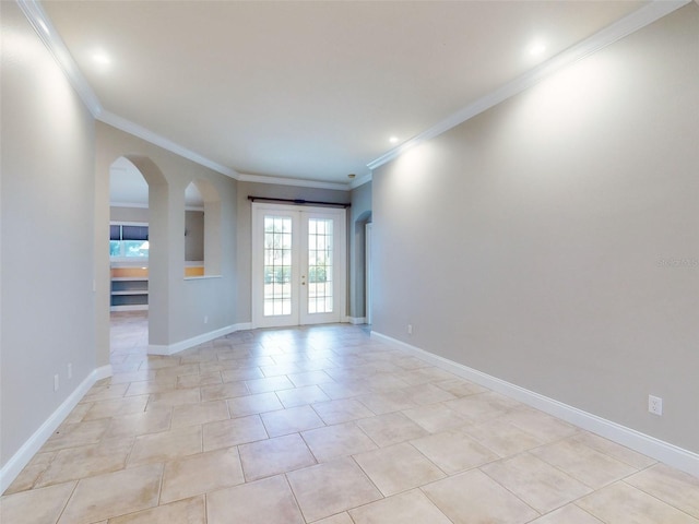 spare room with light tile patterned floors, crown molding, and french doors