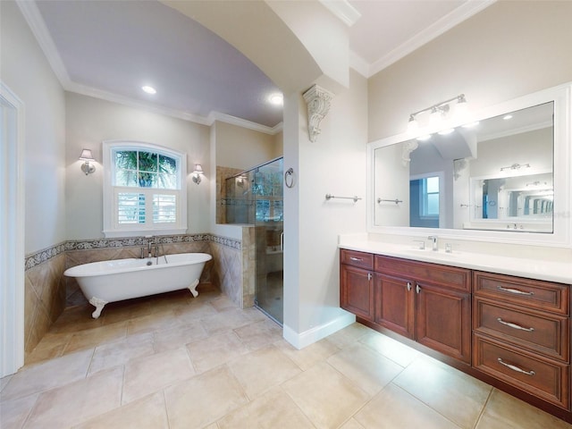 bathroom with crown molding, vanity, plus walk in shower, and tile walls