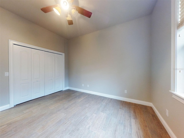 unfurnished bedroom with a closet, ceiling fan, and light wood-type flooring