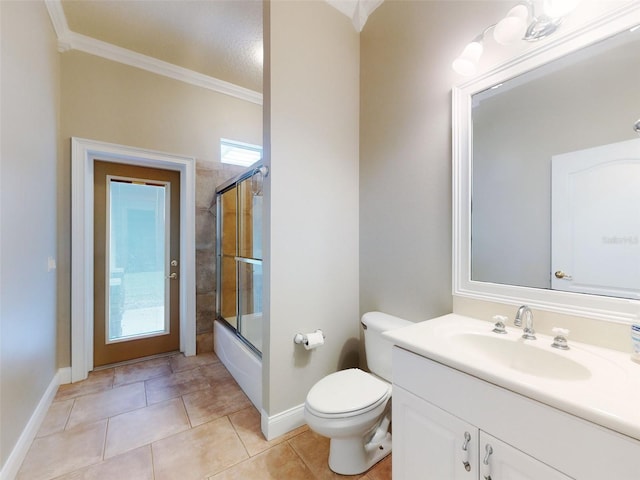 full bathroom featuring crown molding, combined bath / shower with glass door, vanity, tile patterned floors, and toilet