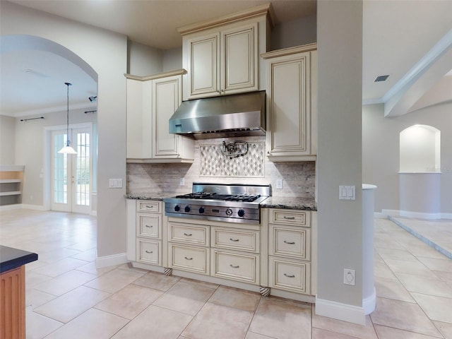 kitchen featuring tasteful backsplash, ornamental molding, stainless steel gas stovetop, and cream cabinets