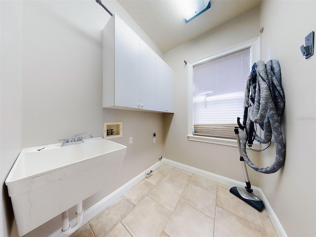 clothes washing area featuring sink, cabinets, light tile patterned floors, electric dryer hookup, and washer hookup