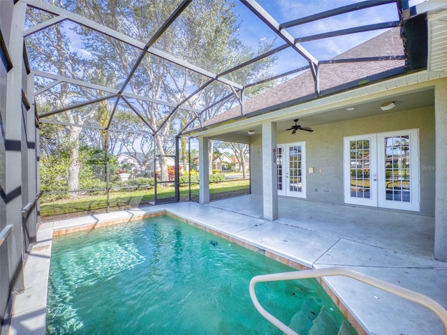 view of swimming pool with french doors, ceiling fan, a lanai, and a patio