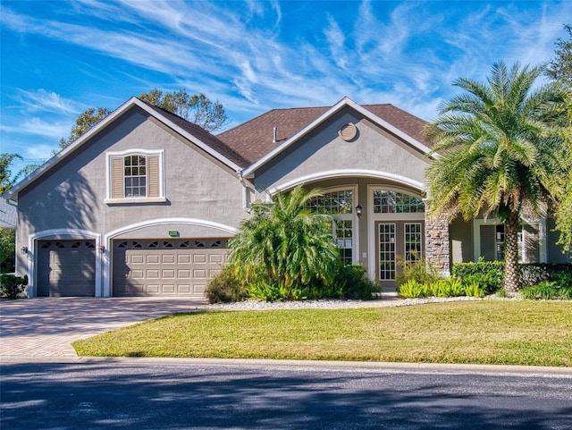 view of front of property featuring a garage and a front lawn