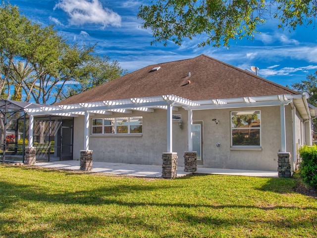 back of property with a yard and a patio area