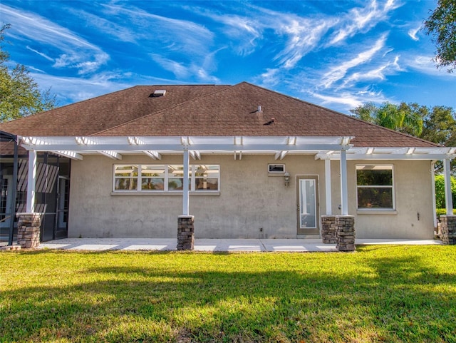 back of property featuring a pergola, a lawn, and a patio area