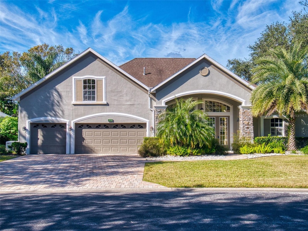 view of front of house with a garage and a front yard