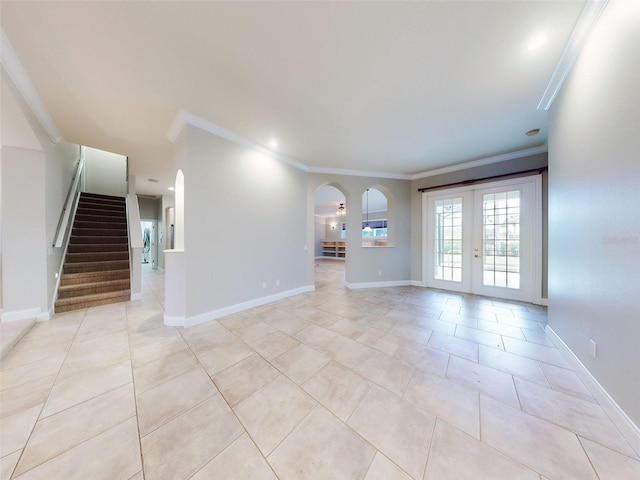 unfurnished living room with crown molding, light tile patterned floors, and french doors