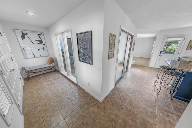 hall with dark tile patterned flooring