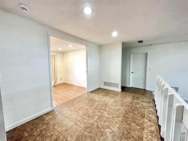 spare room featuring a textured ceiling