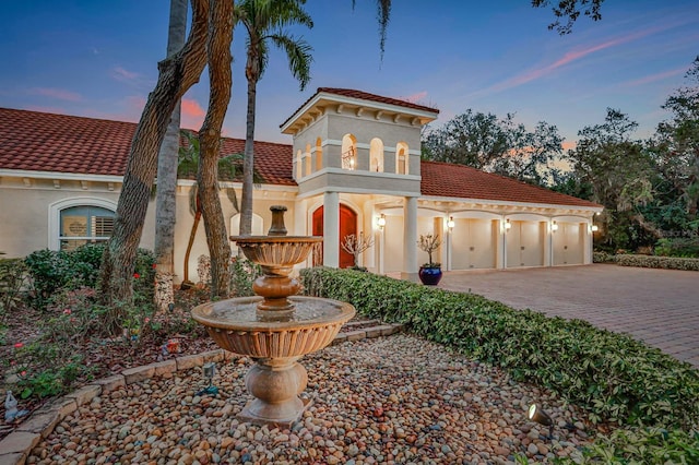 mediterranean / spanish-style home with a garage