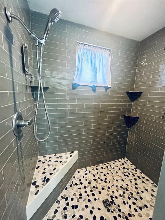 bathroom with tiled shower