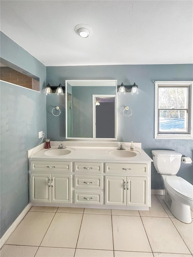 bathroom featuring tile patterned floors, toilet, and vanity