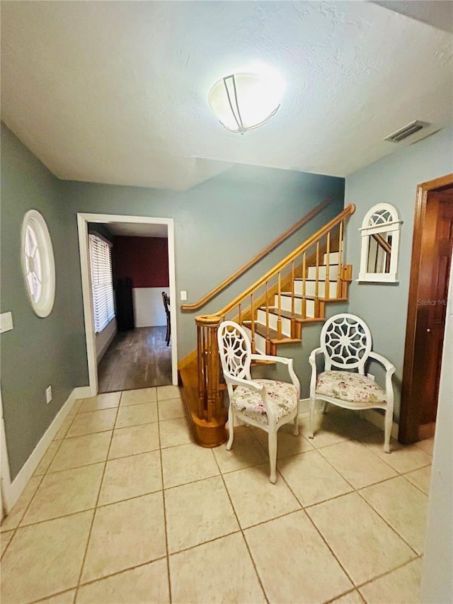 staircase featuring tile patterned floors