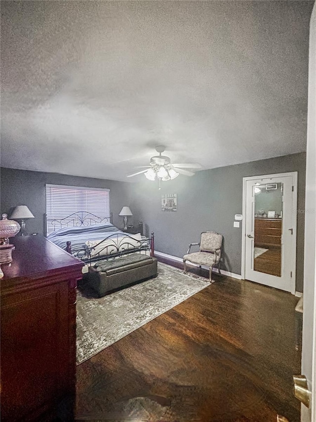 bedroom featuring hardwood / wood-style flooring, a textured ceiling, and ceiling fan