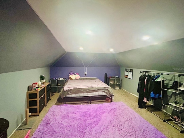 bedroom with lofted ceiling and carpet floors