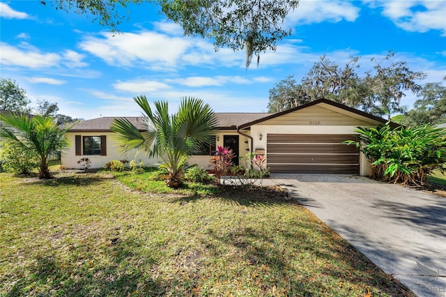 ranch-style home featuring a garage and a front yard