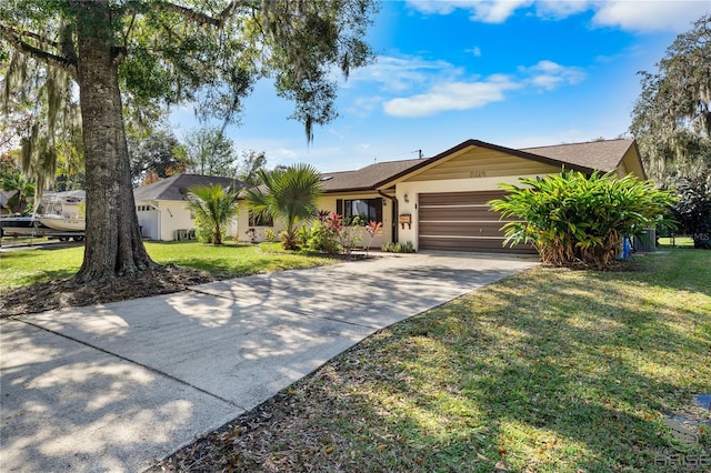 single story home featuring a garage and a front yard