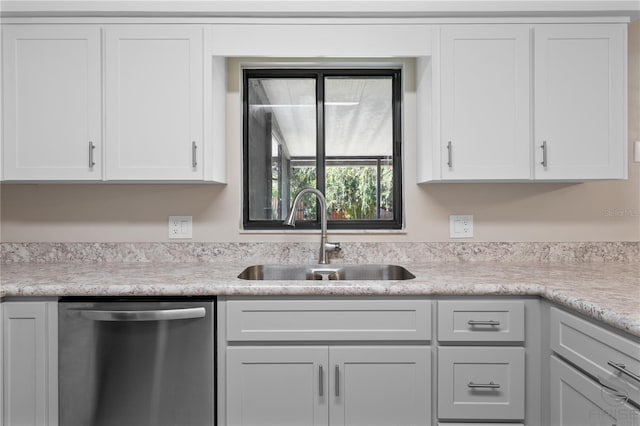 kitchen with dishwasher, sink, and white cabinets