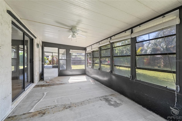 unfurnished sunroom with ceiling fan