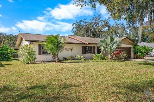 ranch-style home featuring a garage and a front yard