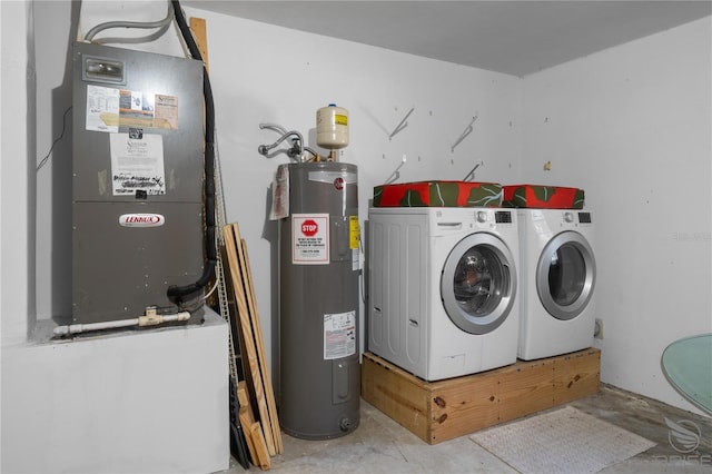 washroom with electric water heater and independent washer and dryer