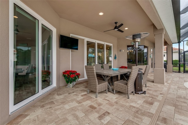 view of patio featuring glass enclosure and ceiling fan