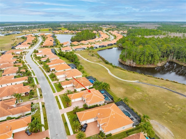 birds eye view of property with a water view