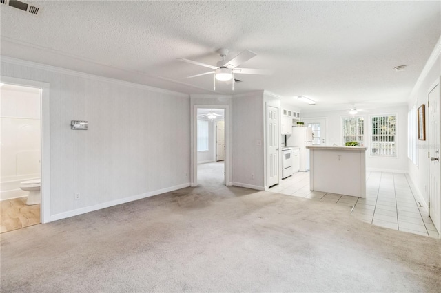 unfurnished living room featuring crown molding, ceiling fan, light carpet, and a textured ceiling