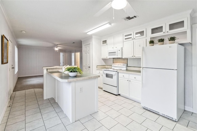 kitchen featuring white cabinetry, a kitchen island, ceiling fan, and white appliances