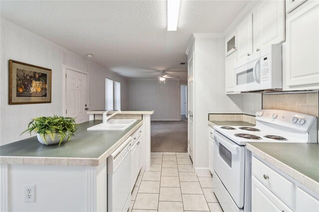 kitchen featuring sink, white appliances, ceiling fan, a textured ceiling, and white cabinets