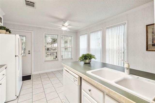 kitchen featuring sink, a textured ceiling, ornamental molding, white appliances, and white cabinets