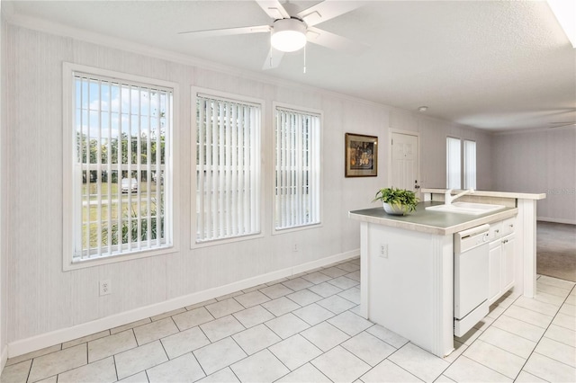 kitchen featuring sink, white cabinets, a kitchen island with sink, ceiling fan, and white dishwasher