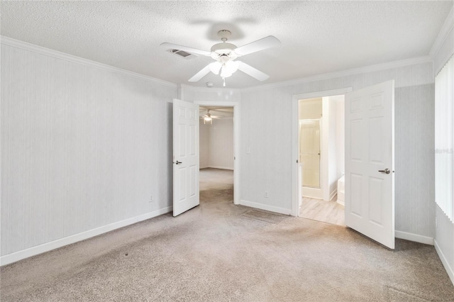 unfurnished bedroom featuring crown molding, light carpet, ceiling fan, and a textured ceiling