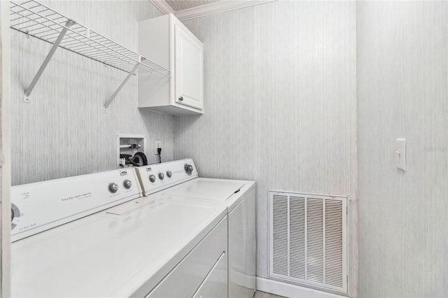 laundry room featuring cabinets and separate washer and dryer