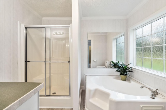 full bath featuring a garden tub, a shower stall, ornamental molding, and a textured ceiling