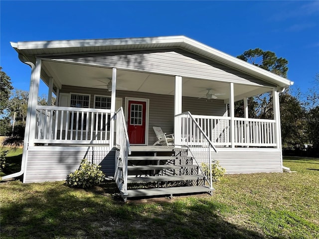 exterior space with ceiling fan, stairs, a front lawn, and a porch