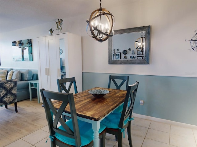 dining space with a chandelier and light tile patterned flooring