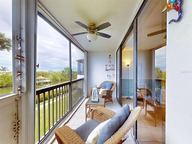 sunroom / solarium featuring ceiling fan