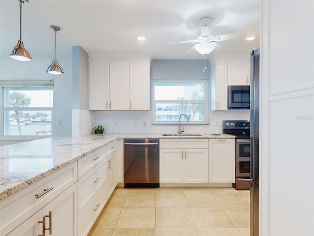 kitchen featuring appliances with stainless steel finishes, sink, and white cabinets