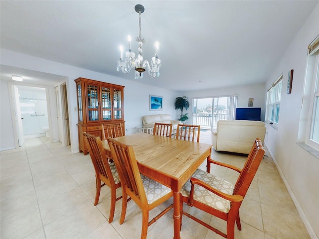 tiled dining space with an inviting chandelier